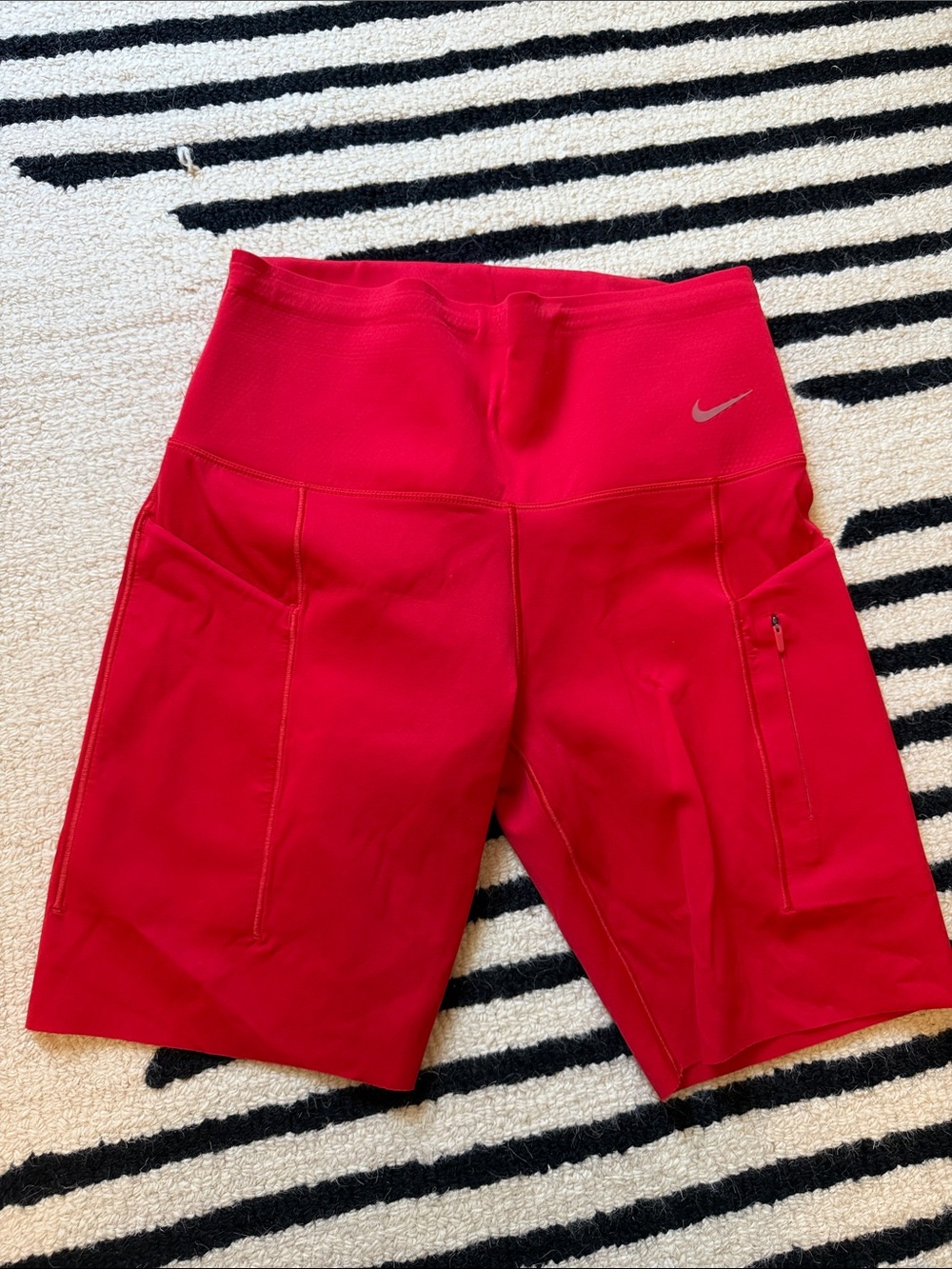 Nike Go High-Waisted Biker Shorts featuring convenient side pockets red size m